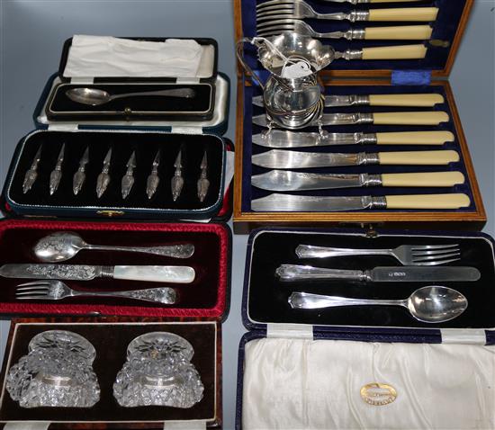Two cased silver Christening trios, a silver cream jug and spoon and three cased sets including glass salts.
